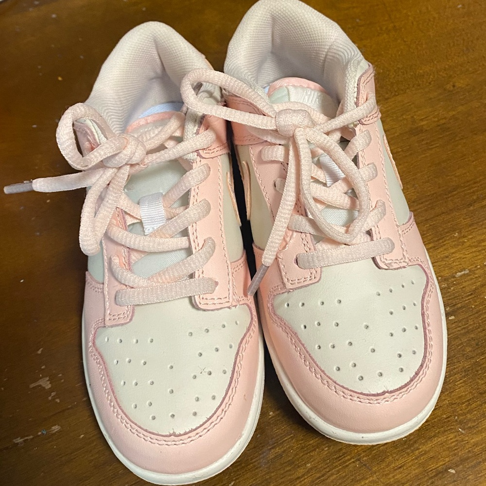 Pink and white children’s  Nike dunks